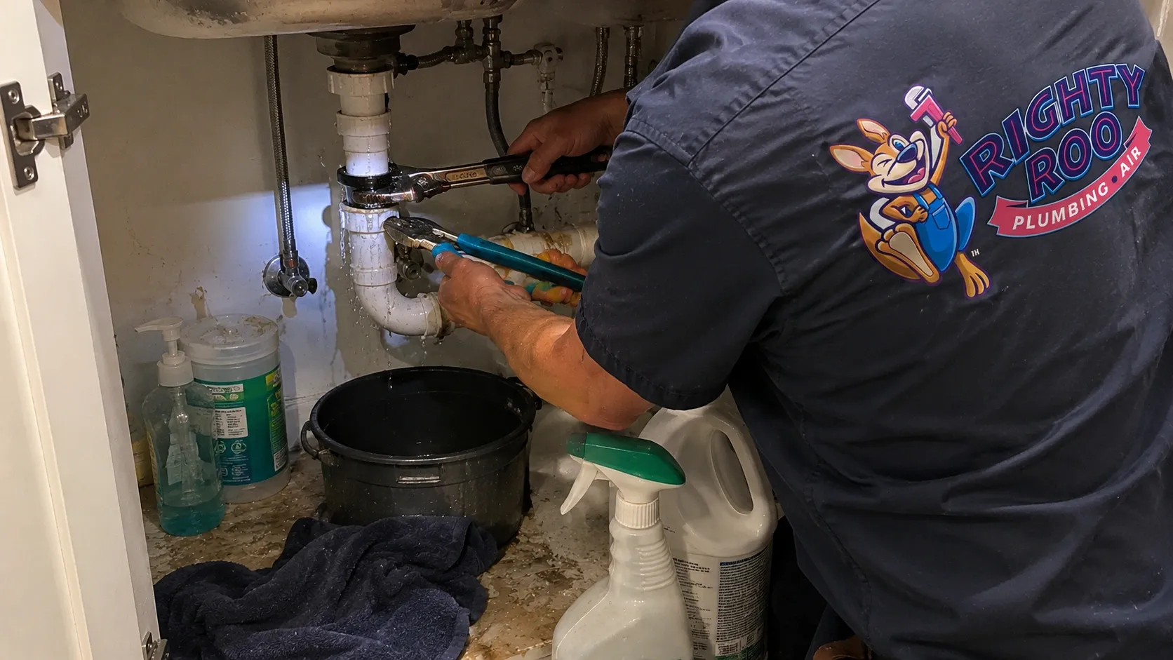 A Righty Roo plumber working under a sink